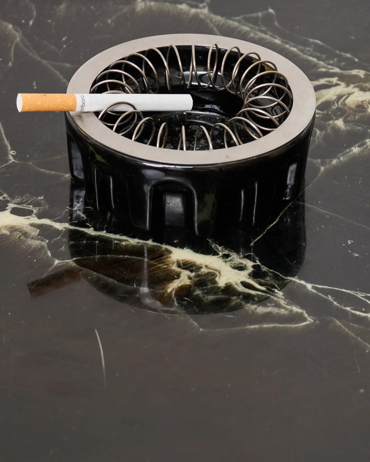 Black glazed ceramic and metal ashtray, 1980s
