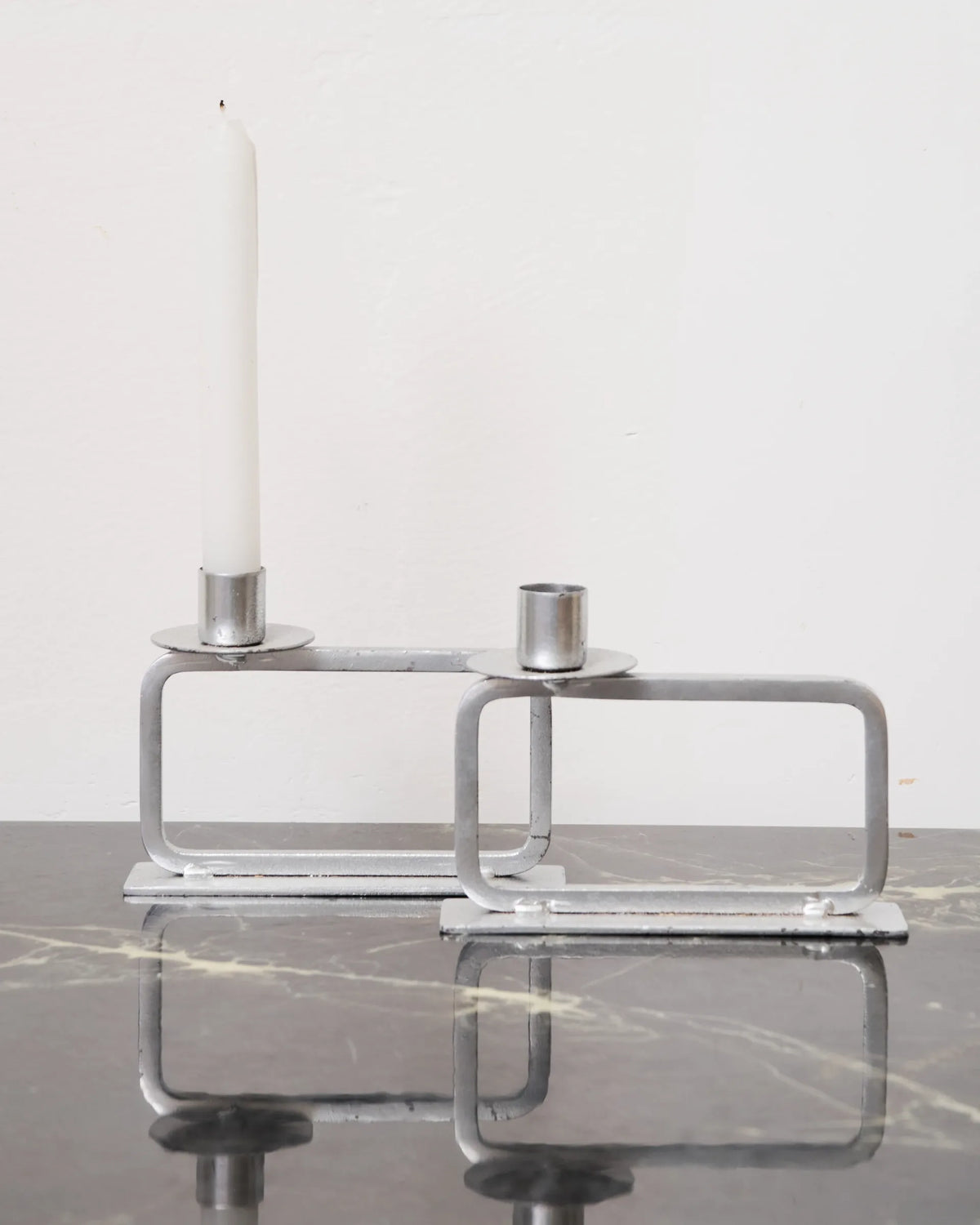 Pair of candle holders on a rectangular base, 1990s